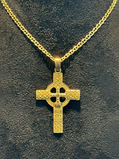 14 kt Gold Celtic cross pendant on a gold chain against a dark background